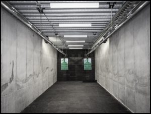 The shooting range at the Survival Condo Project. Hall said that the hardest part of the project was sustaining life underground. He studied how to avoid depression (add more lights) and prevent cliques (rotate chores). Photograph by Dan Winters for The New Yorker